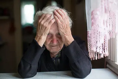 An elderly woman in a state of depression.